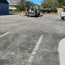Reclaiming-asphalt-parking-lot-sealcoating-and-repair-asphalt-patching-was-needed-removal-of-grass-and-encroaching-debris-air-clean-wire-brush-and-scrub-blacktop-prior-to-seal-coating-and-striping 0