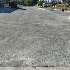 Reclaiming-asphalt-parking-lot-sealcoating-and-repair-asphalt-patching-was-needed-removal-of-grass-and-encroaching-debris-air-clean-wire-brush-and-scrub-blacktop-prior-to-seal-coating-and-striping 1