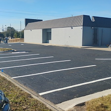 Reclaiming-asphalt-parking-lot-sealcoating-and-repair-asphalt-patching-was-needed-removal-of-grass-and-encroaching-debris-air-clean-wire-brush-and-scrub-blacktop-prior-to-seal-coating-and-striping 2